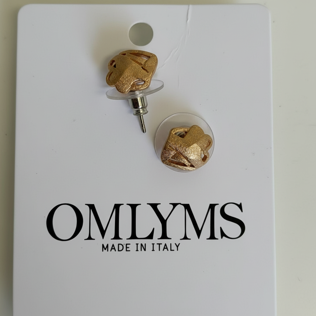 Gold textured geometric stud earrings on OMLYMS packaging